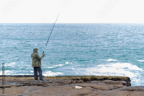 Man fishing in the cliff