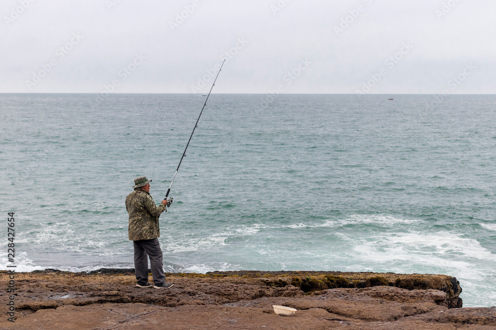 Man fishing in the cliff