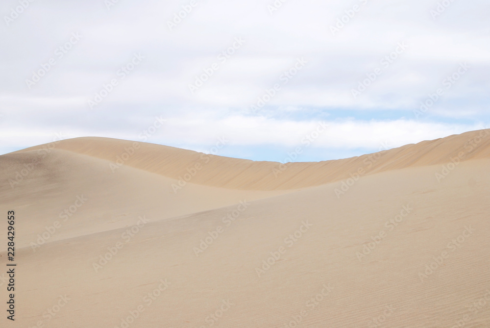 Sand dunes clean background with cloudy sky