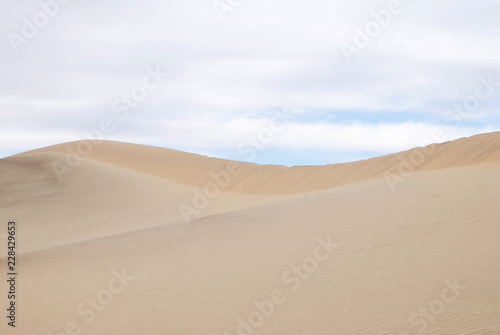Sand dunes clean background with cloudy sky