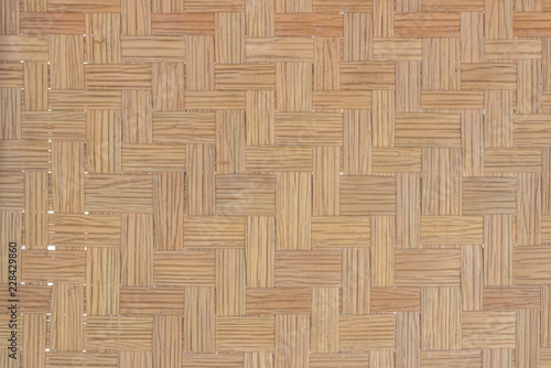 Brown Mat Traditional handicraft bamboo weave texture background. Wicker surface pattern material for wall with antique cracking furniture painted weathered white vintage peeling wallpaper or board.