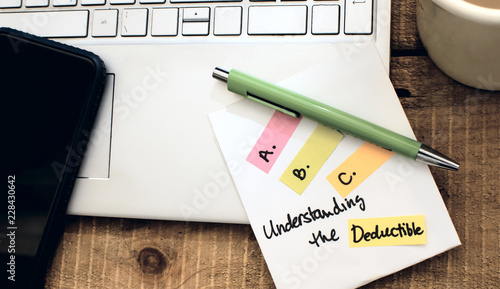 Insurance concept understanding deductible in claims and insurance policy documents notebook with list of Insurance terms