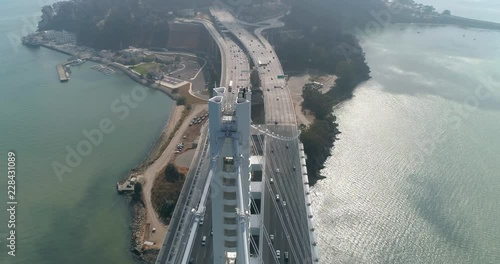Aerial shot of vehicles moving on San Francisco‚ÄìOakland Bay Bridge with city in background