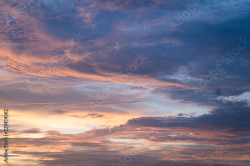 Sunset sky with curve cloud in blue and yellow color