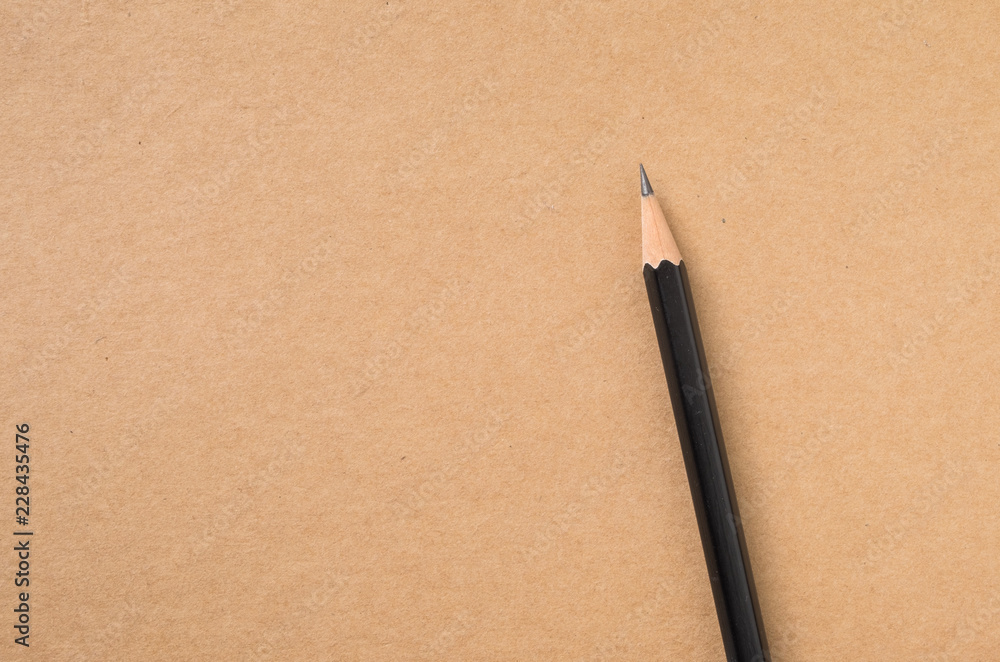 Pencil on brown kraft paper texture top view for backgroun Pencil on brown kraft paper texture top view for backgroun