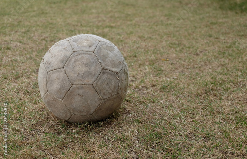 Old soccer ball on grass ground © korkeng