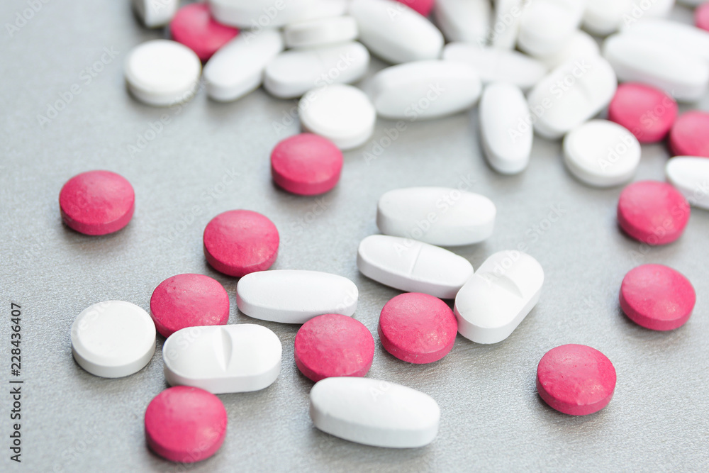 A bunch of colorful pills on a gray background.Medical topic A bunch of colorful pills on a gray background.Medical topic