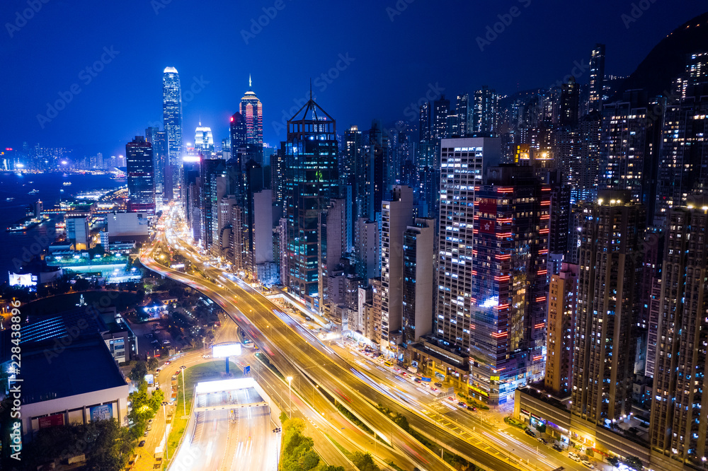 Hong Kong skyscraper and traffic trail at night