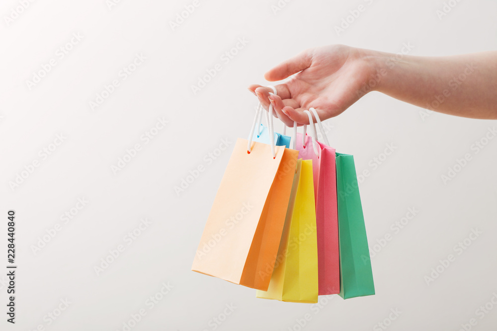 womens hand with paper bag isolated on white