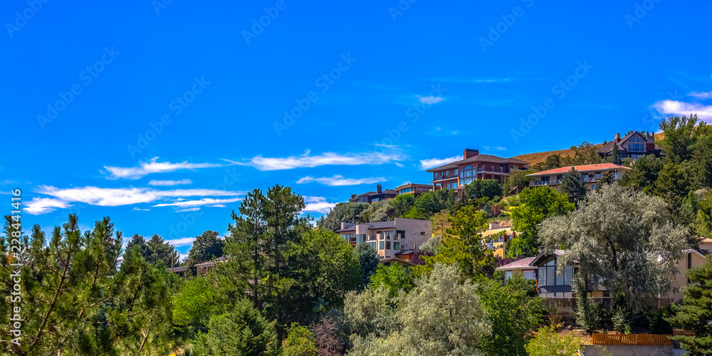 Homes on hill under blue sky in Salt Lake City