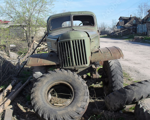 old abandoned rusty military truck on the side of the road