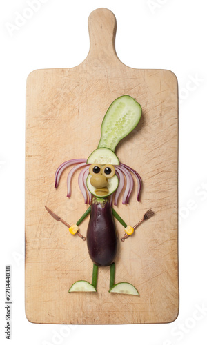 Amusing cock compiled from eggplant and cucumber on cutting board