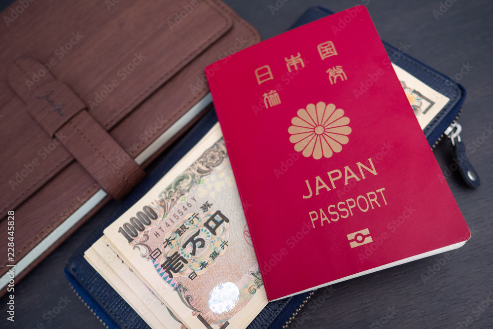 Travel or tourism concept. Japanese passport with note on table Travel or tourism concept. Japanese passport with note on table