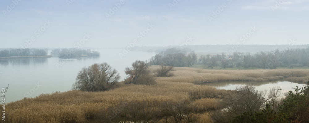 Panoramic view of the Dnieper River in a foggy haze. Beautiful autumn landscape. Zaporozhye region, Ukraine