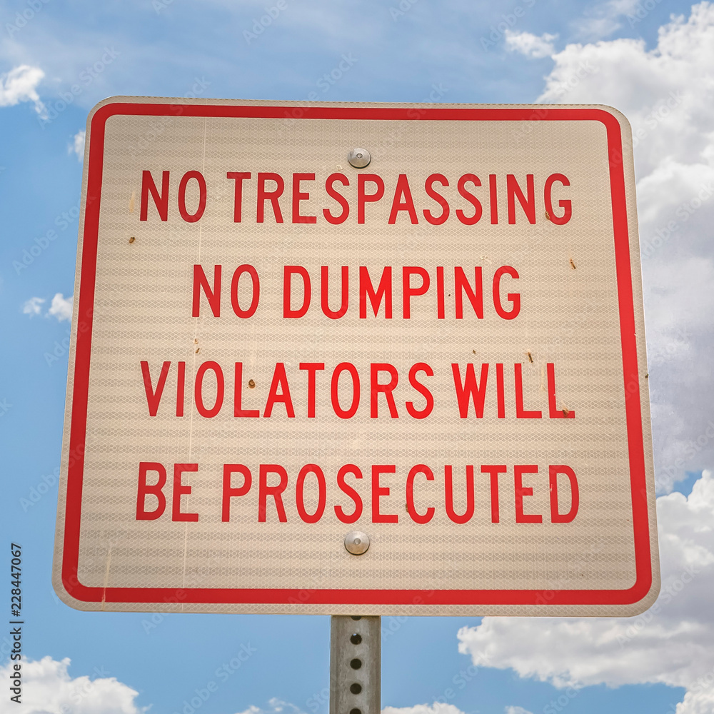 No trespassing and no dumping sign close up No trespassing and no dumping sign close up