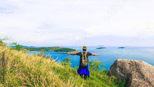 Men love to travel and hiking Adventure photographed young Thai people in Asia. Take yourself while walking on the mountains near the sea. View at Krating Cape, Phuket, Thailand