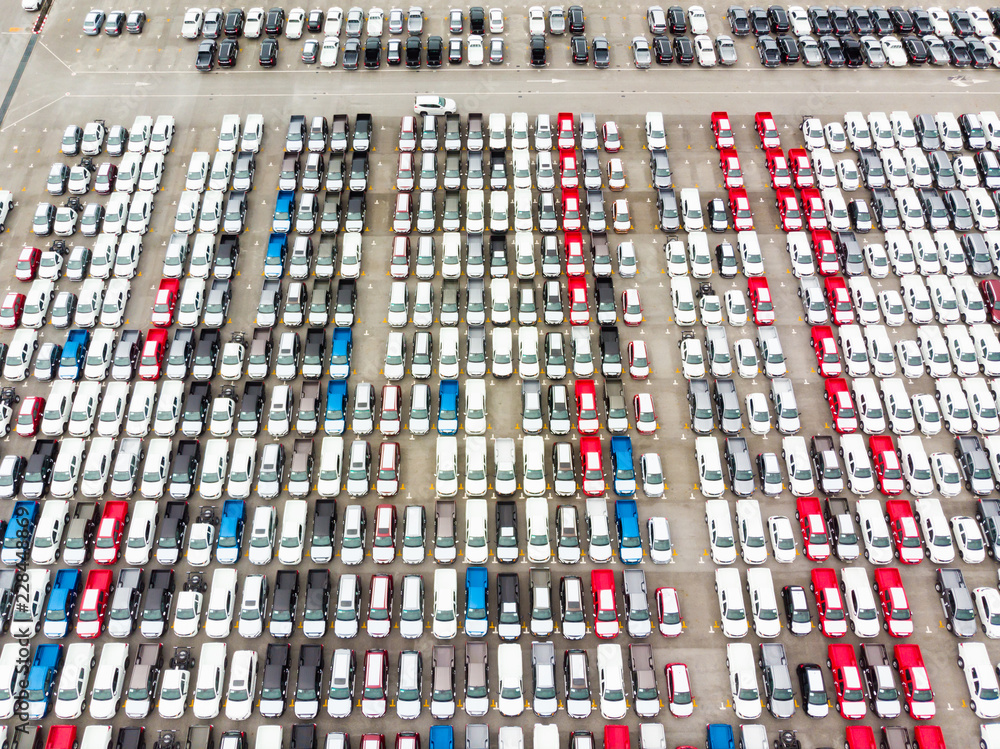 Obraz premium Aerial top view photo from flying drone, New Cars produced Several times a year at industrial estate for import export around in the world
