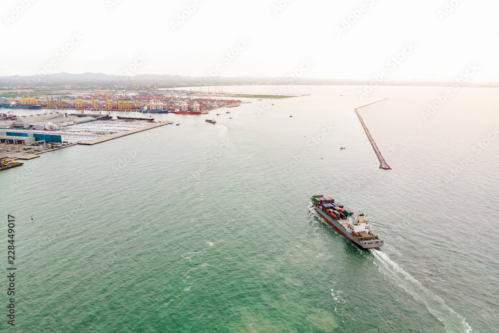 Obraz premium Aerial view of Small container ship at sea freight, Business International trade and Container logistics export-import harbor to the International port / Shipping Containers concept.