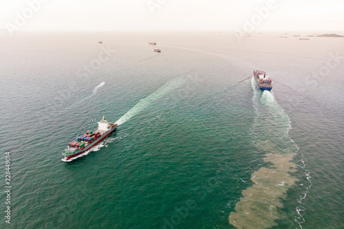 Aerial view of Small container ship at sea freight, Business International trade and Container logistics export-import harbor to the International port / Shipping Containers concept.