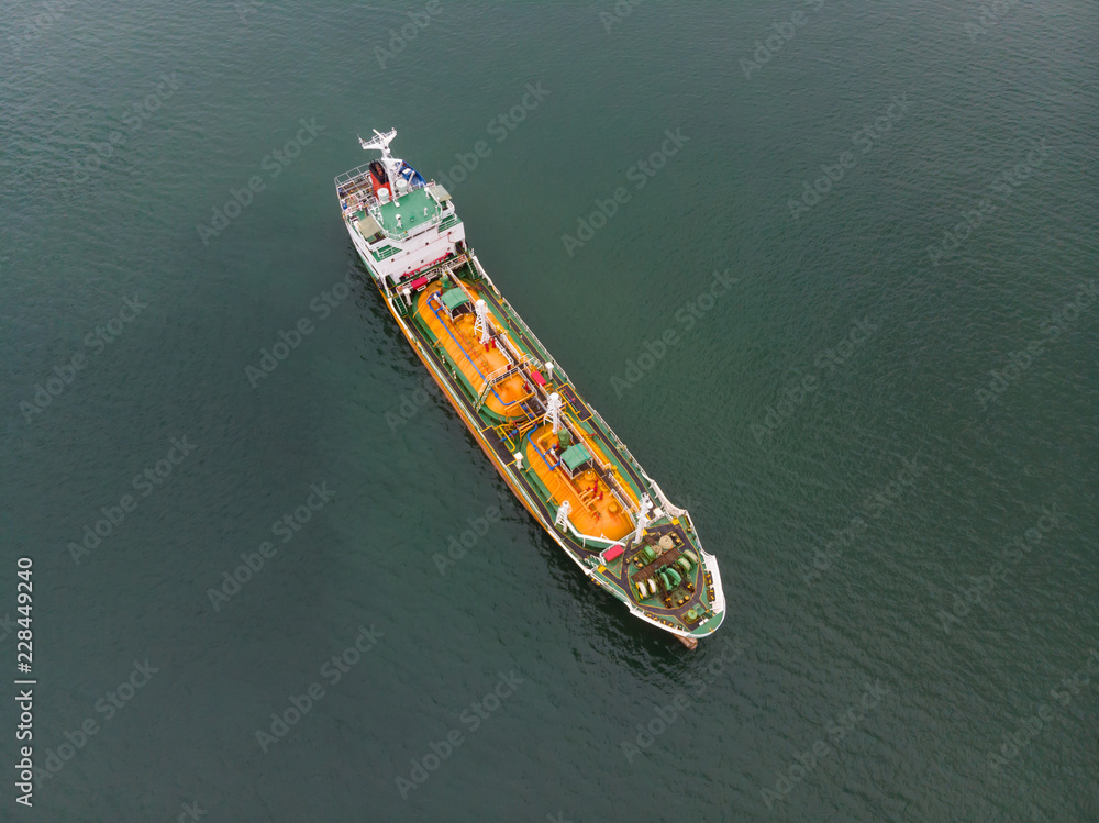 Aerial Top View of sea freight, Crude oil tanker lpg ngv at industrial estate Thailand / Crude Oil tanker to Port of Singapore - import export around in the world