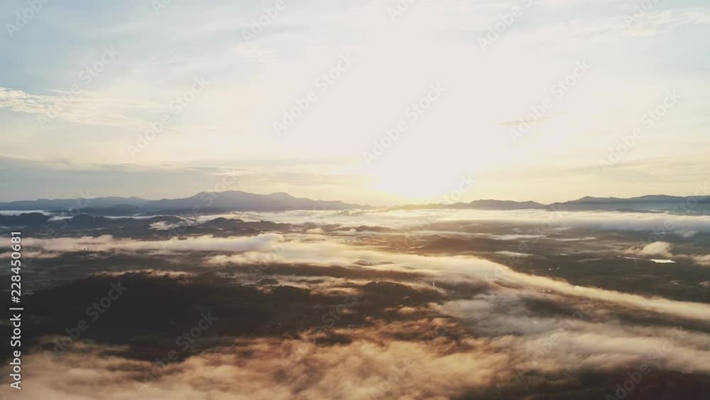 Aerial view drone shot of flowing fog waves on mountain tropical rainforest in phang nga thailand Aerial view drone shot of flowing fog waves on mountain tropical rainforest in phang nga thailand