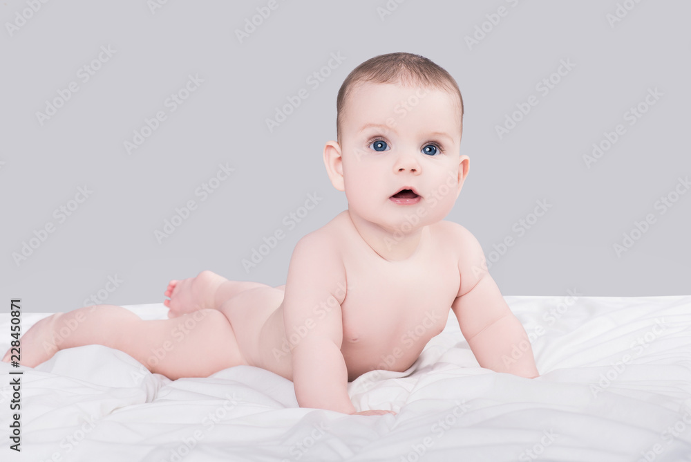 cute little baby girl or boy lying on soft blanket isolated on grey cute little baby girl or boy lying on soft blanket isolated on grey