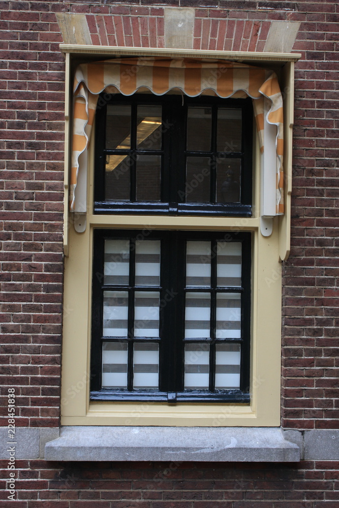 window with Curtain in the Dutch Citz with red brick wall.