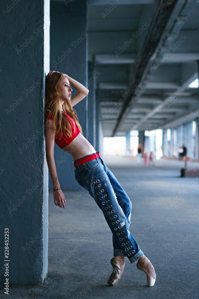 Ballerina dancing in jeans, t-shirt and pointe. Street performance. Modern  ballet. Slim girl dancing on tiptoe. Passion and art Stock Photo | Adobe  Stock