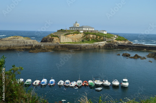 Beautiful Views Of The Fishing Port With The Lighthouse On The Background In Tapia De Casariego. Nature, Travel, Recreation. August 2, 2018.Tapia De Casareigo, Asturias, Spain.