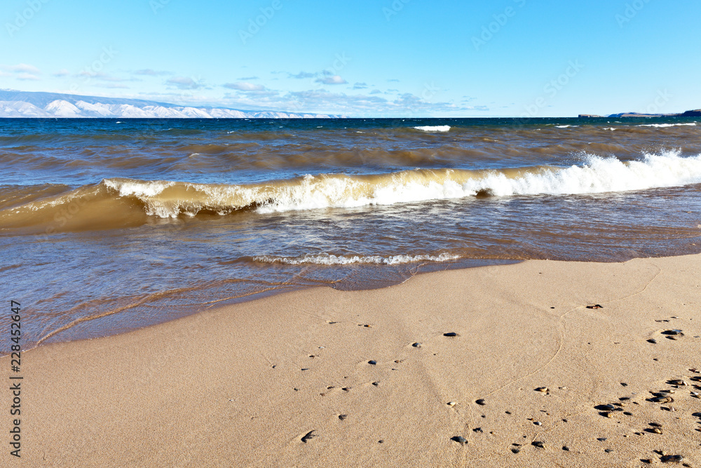 Lake Baikal. Water landscape with a beautiful sandy beach in the Sarayskiy Bay on the island of Olkhon on a windy autumn day