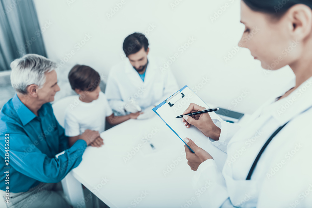 Fototapeta premium Doctor Taking Blood Sample from Boy's Finger.