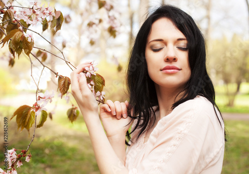 lifestyle and people concept: Beautiful woman in blossom garden photo