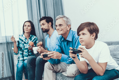 Happy Family Playing on Console Together at Home.