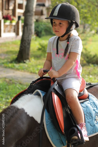 little girl riding a horse