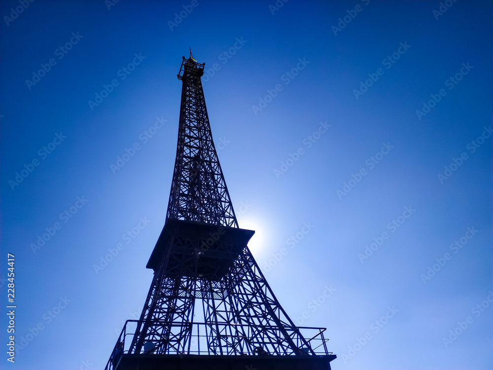Eiffel Tower replica made of steel against a blue sky without clouds.