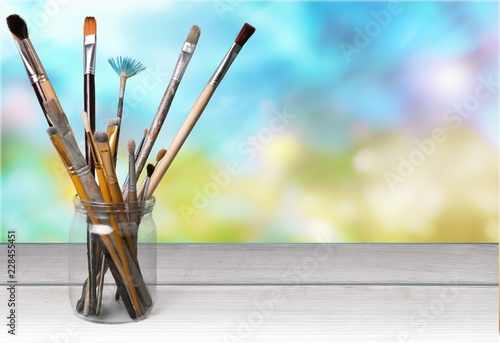 Fototapeta Naklejka Na Ścianę i Meble -  Brushes on wooden table on background
