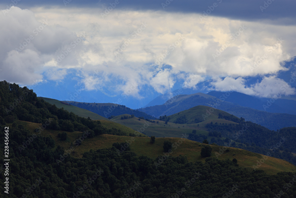 Clouds over the hills in the area of Mount Elbrus. Photographed in the Caucasus, Russia.