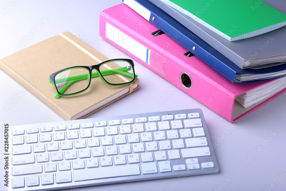 Office desk table with blank notebook, keyboard, other supplies and coffee cup. Top view with copy space Office desk table with blank notebook, keyboard, other supplies and coffee cup. Top view with copy space