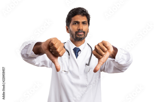 Male practitioner holding two thumbs down.