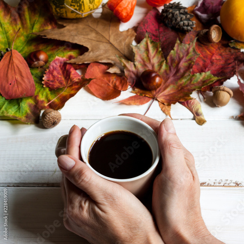 Cup of coffee and autumn leaves. photo