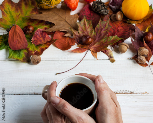 Cup of coffee and autumn leaves. photo