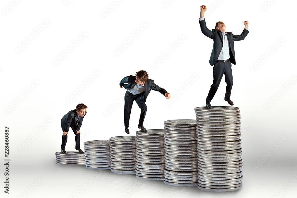 small copies of a businessman climb up the steps. concept - leadership in the financial sector small copies of a businessman climb up the steps. concept - leadership in the financial sector