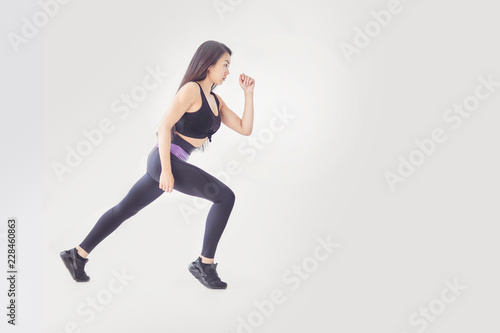 Be motivated! Beautiful sexy fitness woman posing full lengthd. middle eastern female sports clothing relaxing after workout grey background. Muscular female body. Image with copyspace