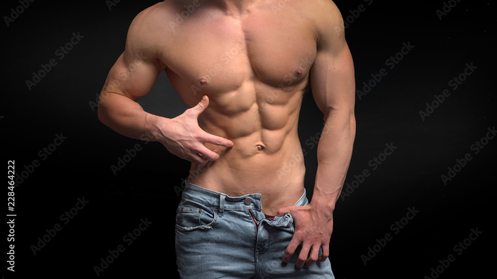 shirtless male torso with perfect abs. Man in blue jeans showing his abs shirtless male torso with perfect abs. Man in blue jeans showing his abs