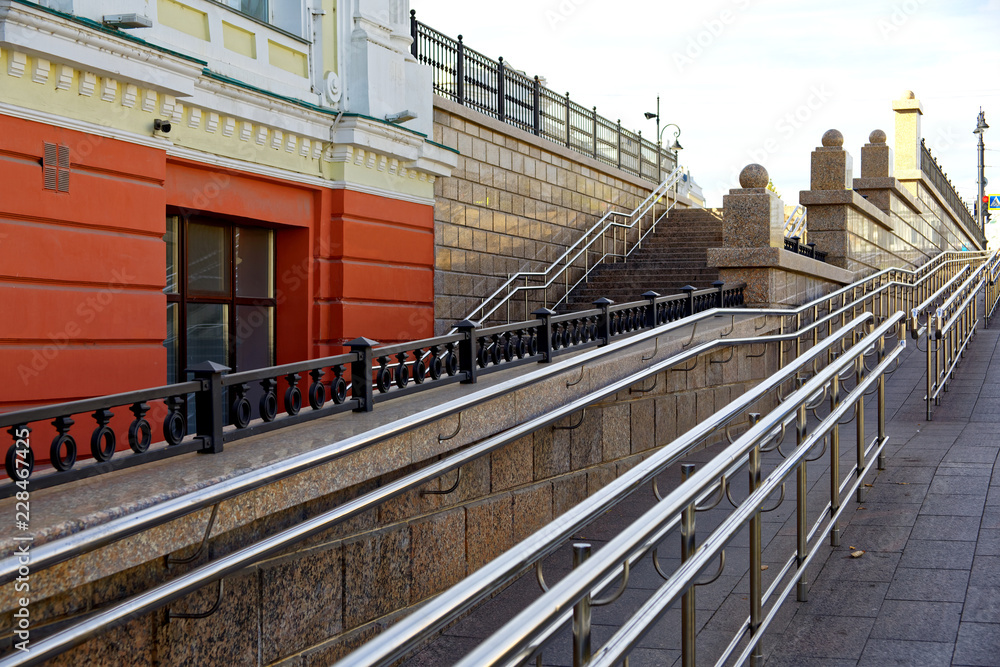 Russia, Omsk. Accessible urban environment, stairs for all categories of people - ordinary pedestrians and wheelchair users