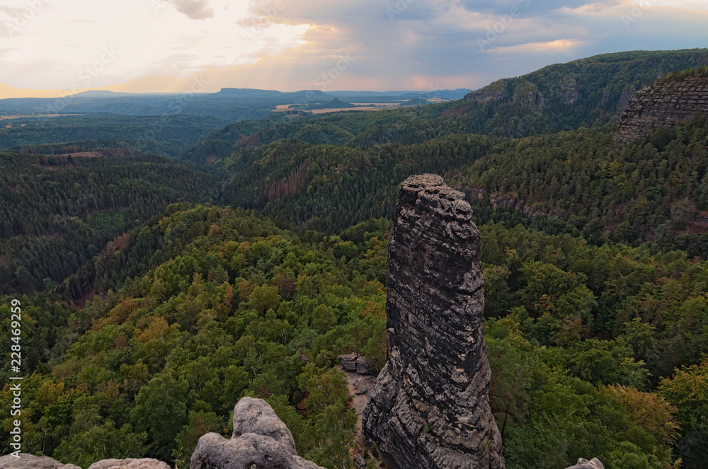 Scenic panorama with typical rocky peaks under thunderstorms clouds. Bohemian Switzerland National Park. Czech Republic