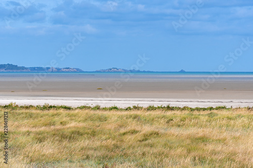 French landscape - Bretagne. A beautiful beach with grass in the foreground.