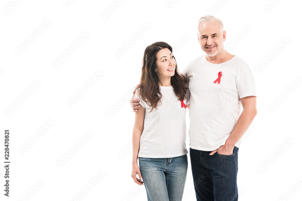 smiling adult interracial couple in blank t-shirts with aids awareness red ribbons embracing isolated on white smiling adult interracial couple in blank t-shirts with aids awareness red ribbons embracing isolated on white