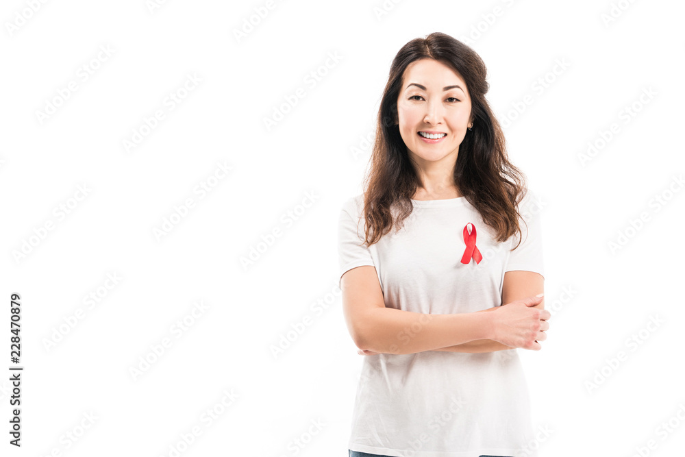 smiling adult asian woman with aids awareness red ribbon on t-shirt looking at camera with crossed arms isolated on white smiling adult asian woman with aids awareness red ribbon on t-shirt looking at camera with crossed arms isolated on white