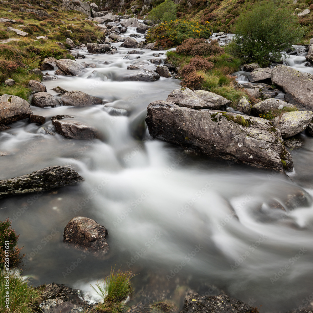 Moody landscape image of river flowing down mountain range near Llyn Ogwen and Llyn Idwal in Snowdonia in Autumn Moody landscape image of river flowing down mountain range near Llyn Ogwen and Llyn Idwal in Snowdonia in Autumn